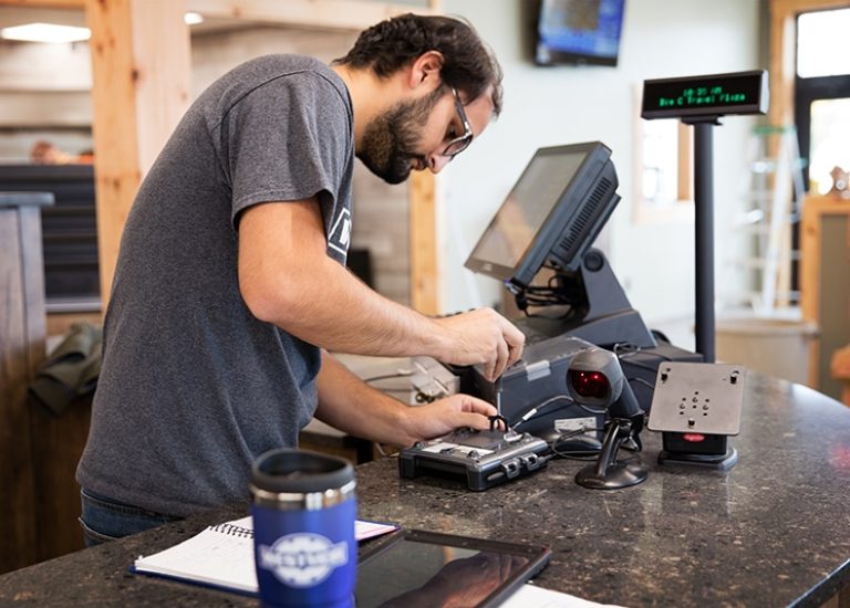 POS-systems-service-tech-installing-at-counter